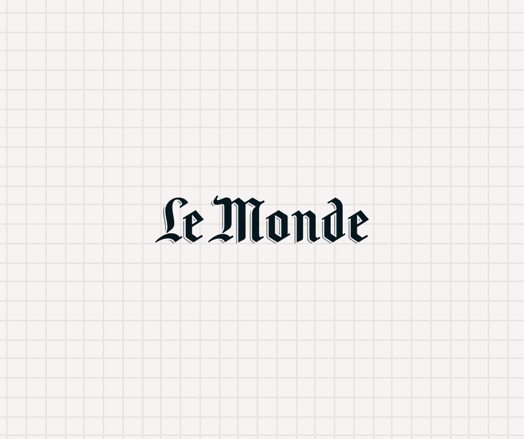 Logo of Le Monde newspaper in blackletter font on a light grid background.
